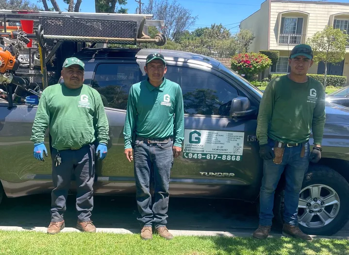 Greenhouse Landscaping & Maintenance crew in uniform with a branded company truck at an Orange County HOA property